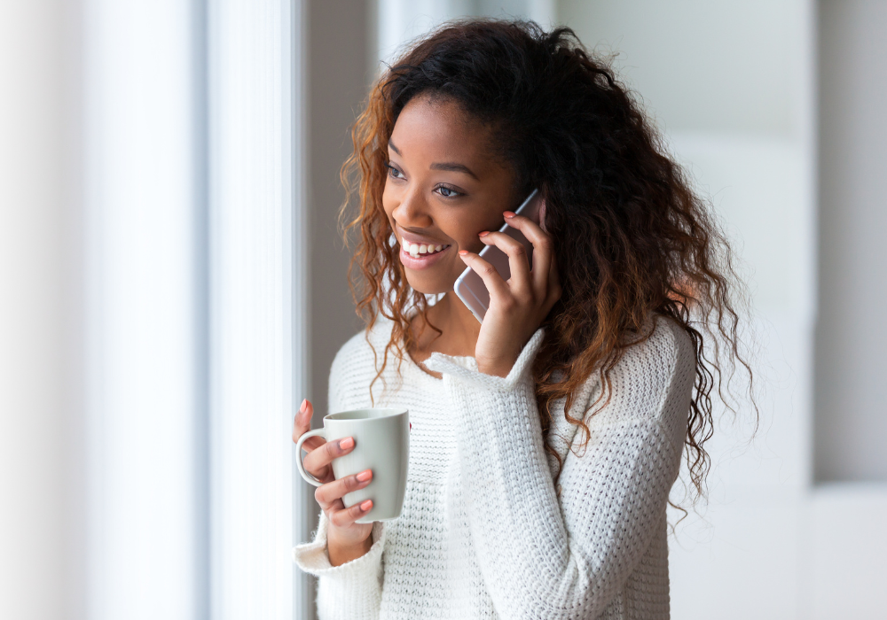 girl-on-phone-coffee-gallery Student holding coffee cup and talking with international calling codes on the phone