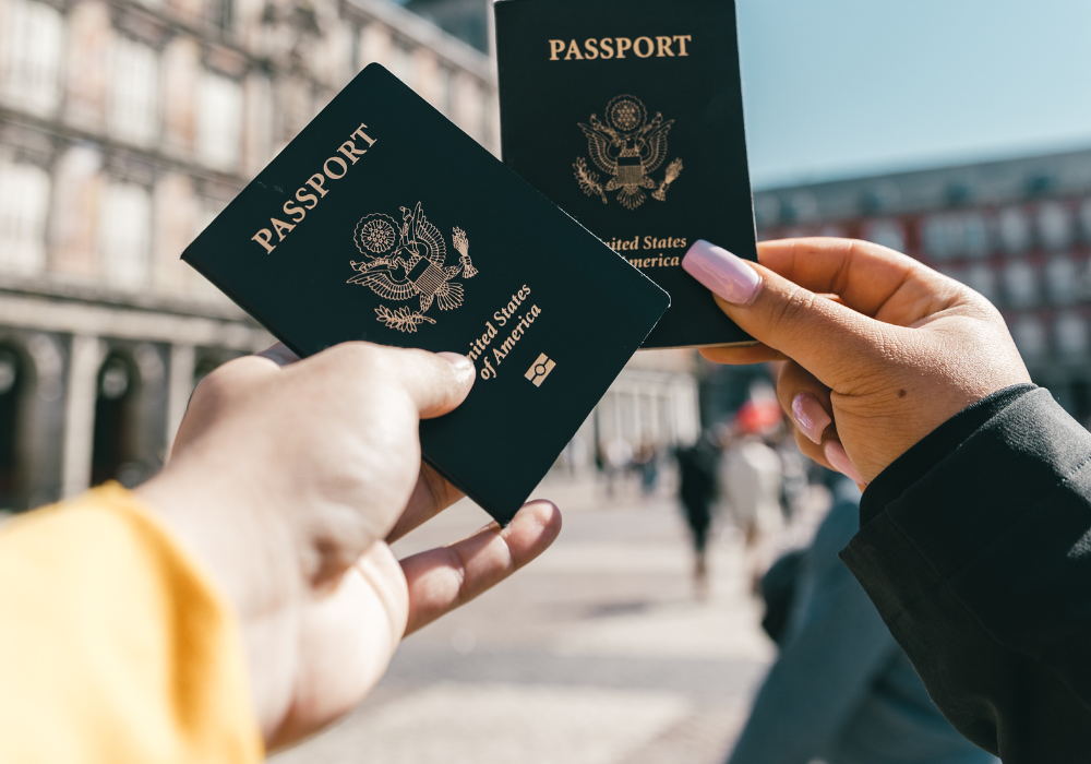 holding-up-passports-gallery Study abroad students holding passports in front of cityscape
