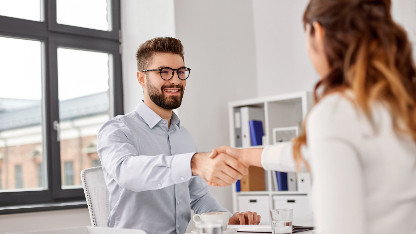 Student shaking hands with interviewer after using study abroad experience to get the job