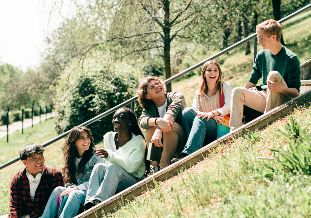 staggered-students-talking-gallery Students sitting outside talking to each other and laughing