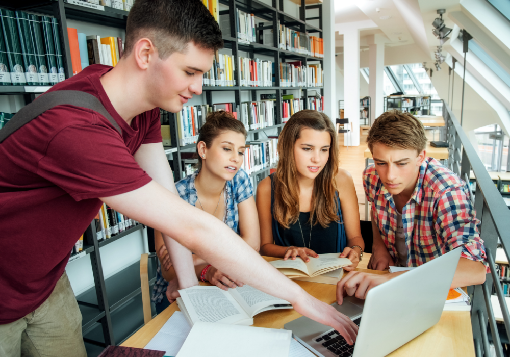 students-pointing-laptop-gallery Students in a library study abroad planning