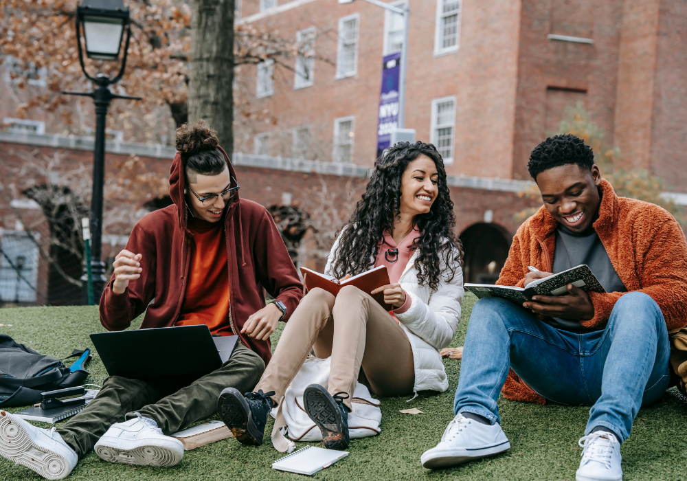 three-students-outside-gallery Study abroad students sitting in the grass together