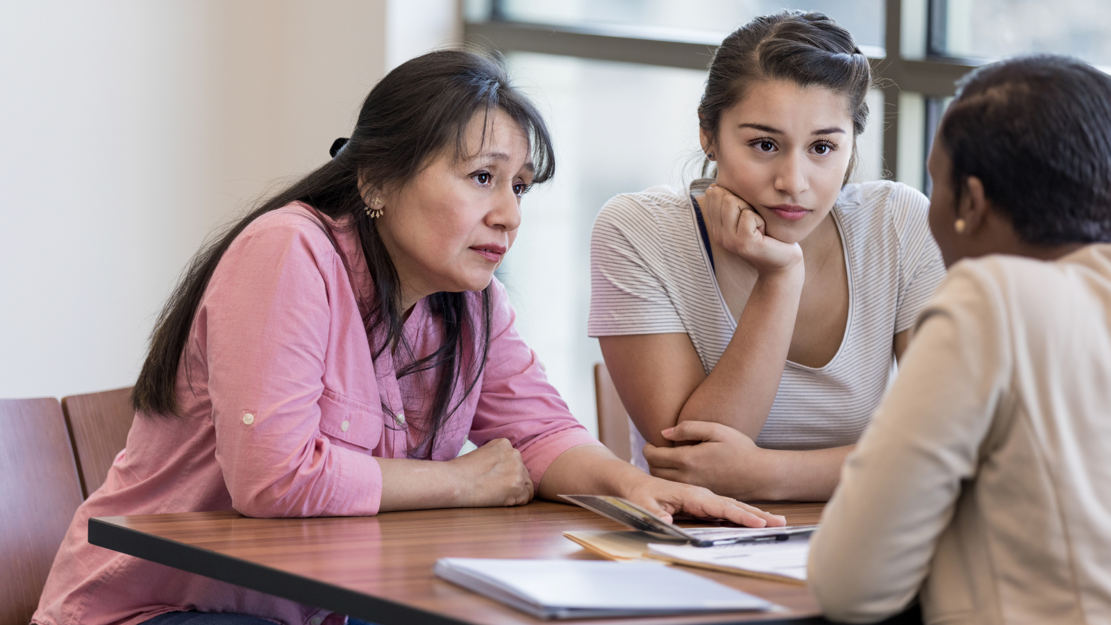 Student and their parent meeting with a banker