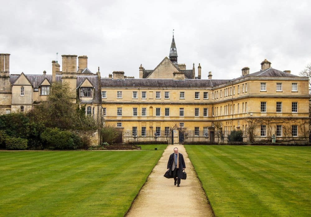 Professor walking across a beautiful European university campus, showcasing academic life and global learning opportunities - Best Courses to Study in Europe