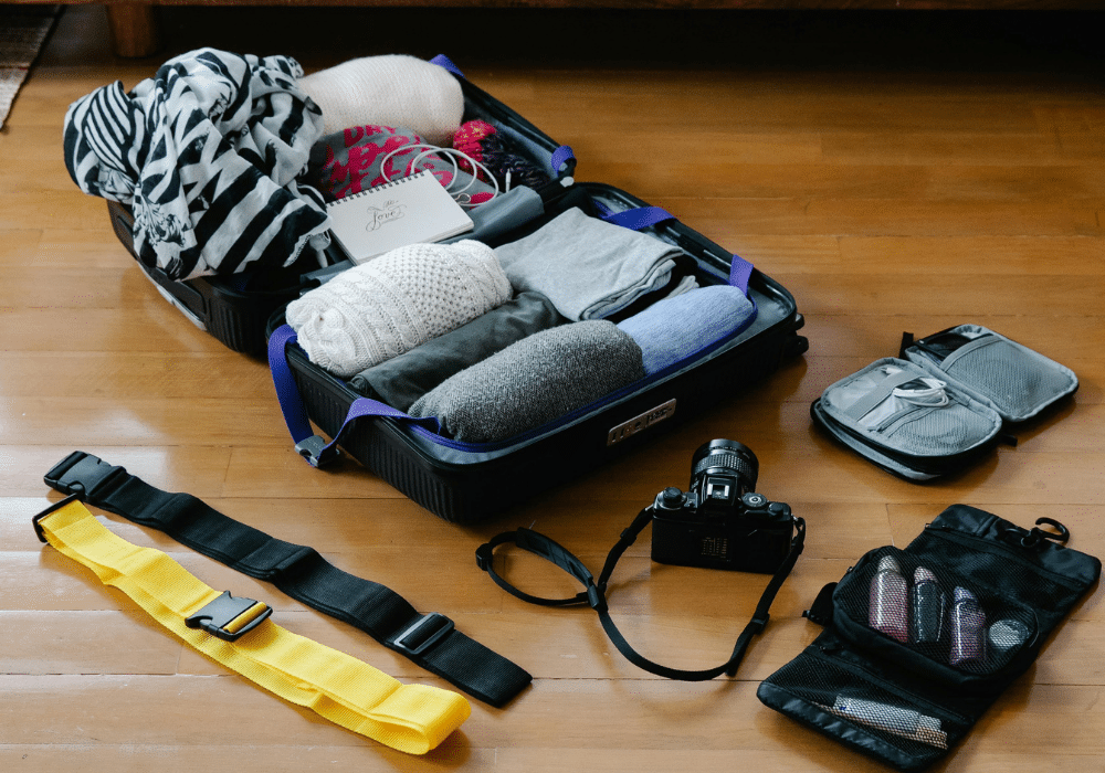 Student packing a suitcase for a semester abroad with essential travel items